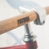 Close-up of a bicycle's wooden handlebars with "FUTURA" logo.