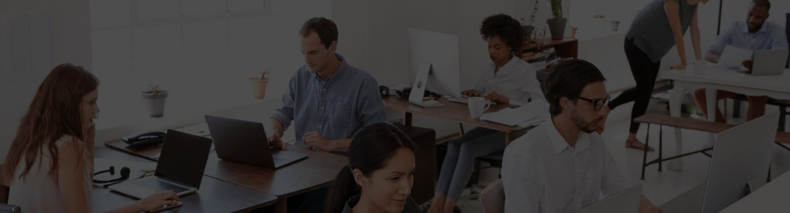 Text: A group of people working in an open-plan office.